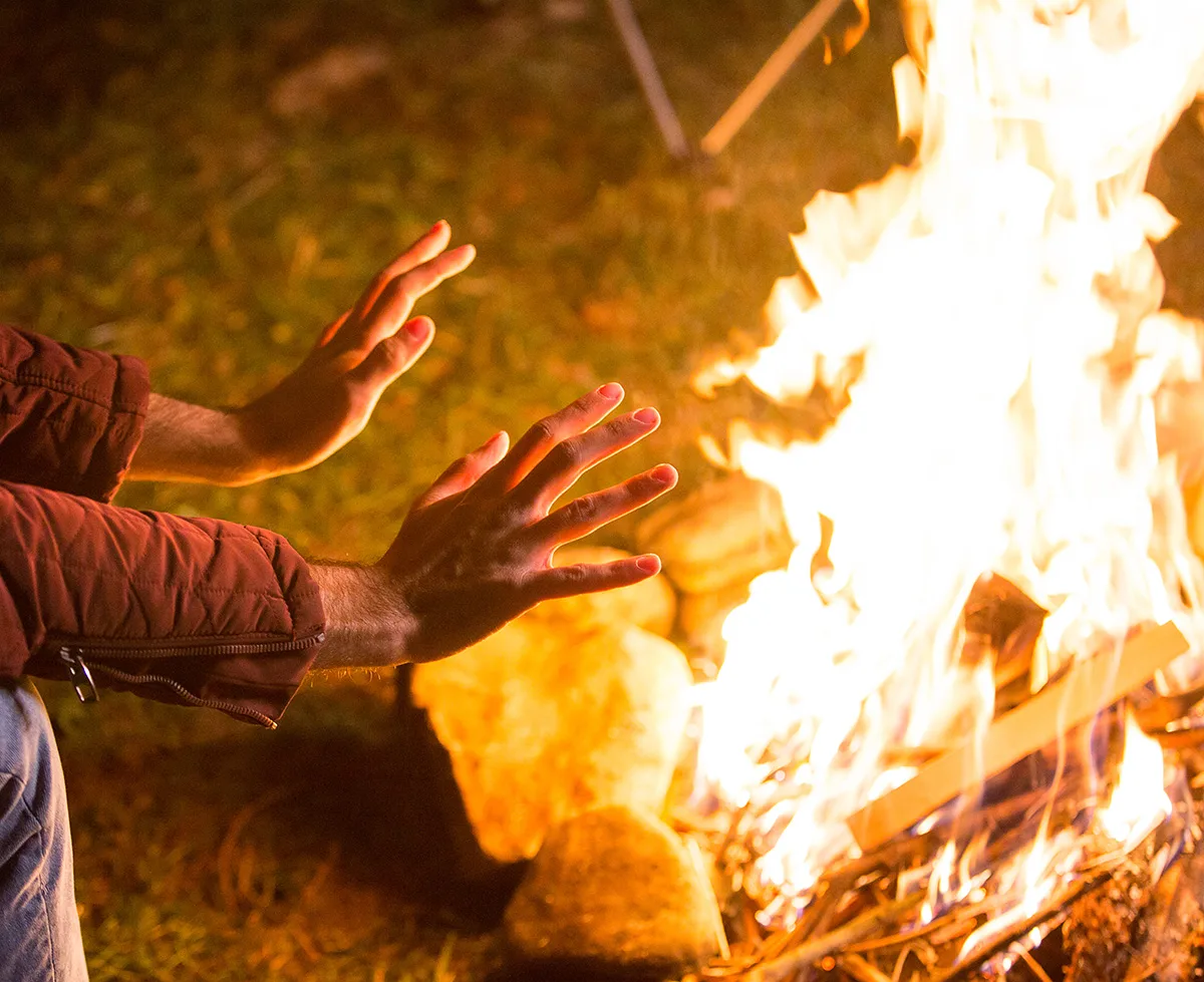 Warming hands on fire